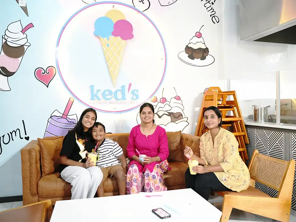 Home 65 Happy family tasting ice cream together at Keds Ice Cream