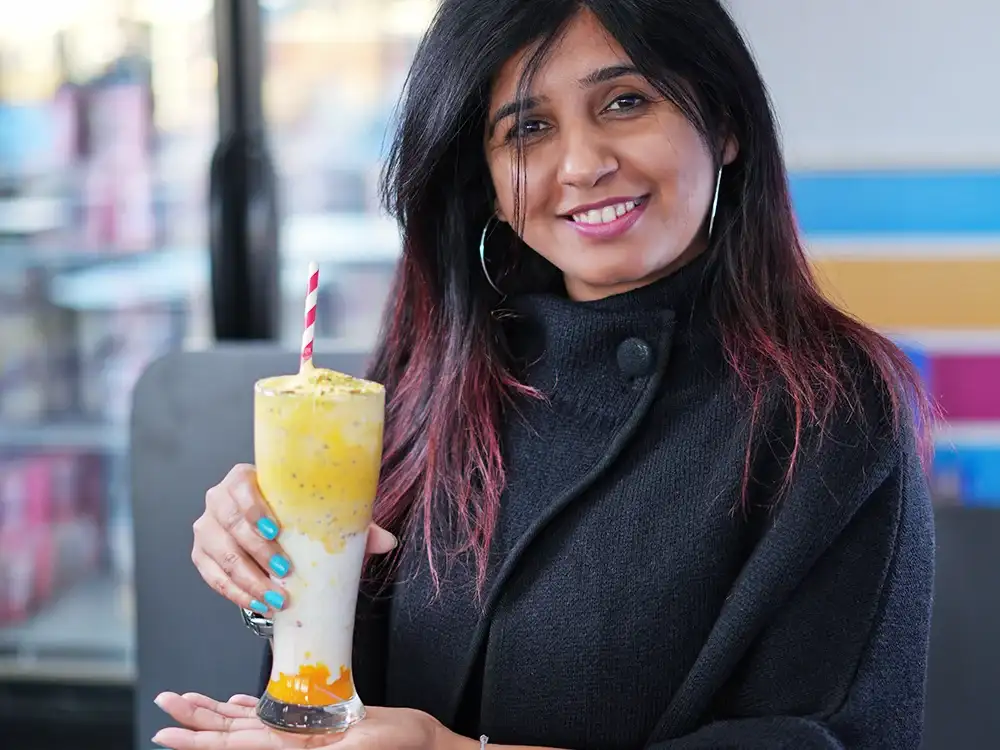 Home 69 Satisfied customer enjoying dessert at Keds Ice Cream