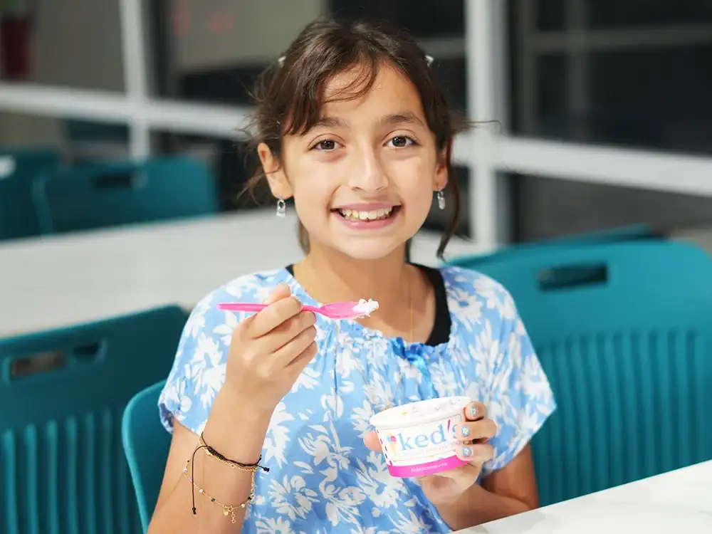 Home 61 Happy little child eating ice cream in Frisco at Keds Ice Cream