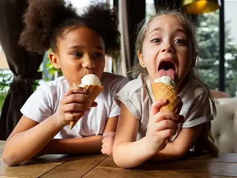 Home 62 Smiling baby eating ice cream at Keds Ice Cream
